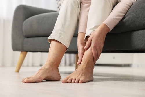 Senior woman experiencing foot and ankle pain from arthritis